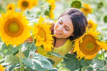 happy young girl in a field with sunflowers