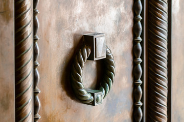 Bronze decorative handle on the entrance door to the catholic Christian Transfiguration Church...