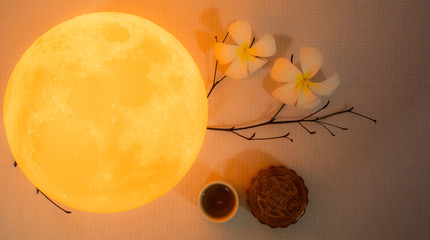 moon cake and tea with full moon and flower