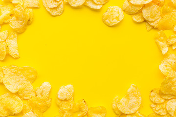 potato chips frame on yellow background top view space for text