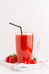 Fresh Tomato juice in a Cup on  napkin with cherry tomatoes