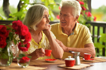 Portrait of happy senior couple drinking coffee