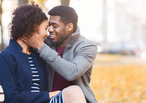 African american man embracing his woman, saying sweet words