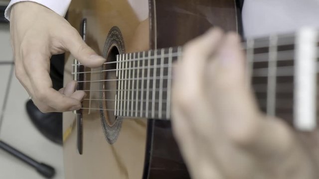 Playing classical guitar. Slow motion. Close up of right hand