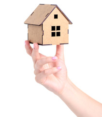 Wooden small house in hand on white background isolation