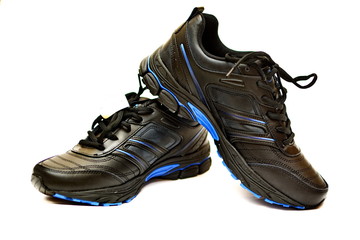 Pair of new black leather sport running shoes on white background. Isolated