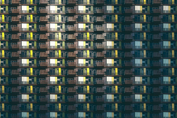 architectural pattern, dark facade with windows and balconies of a miserable berlin house