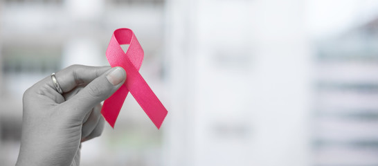 October Breast Cancer Awareness month, Woman holding Pink Ribbon for supporting people living and illness. Healthcare, International women day and World cancer day concept
