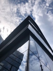 Plakat modern building with blue sky and clouds