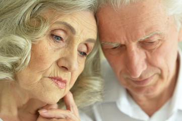 Portrait of beautiful sad senior couple posing