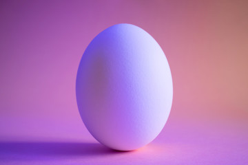 Close-up egg in neon trend color. Protein, a stylish simple meal. Minimalism, place for text, design.