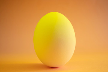 Close-up egg in neon trend color. Protein, a stylish simple meal. Minimalism, place for text, design.