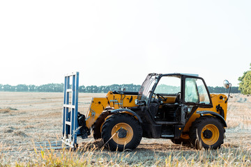modern tractor on wheat field in country