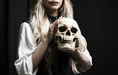 Medium shot of woman holding skull