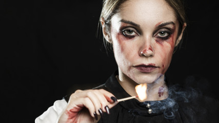 Woman with lit match and copy space