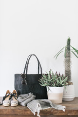 Handmade woven black beach bag tote, white background, styled with cactus and grey scarf, copy space