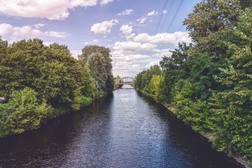 Fototapeta na wymiar beautiful Berlin canal with bridge and cloudscape
