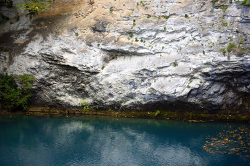 A small lake with incredibly blue water. The lake under the white rock. Abkhazia.