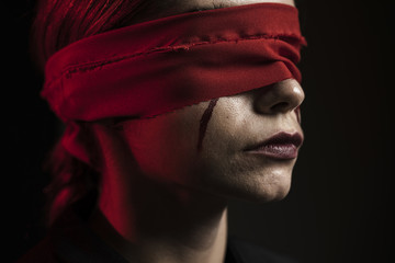 Side view of woman with red blindfold