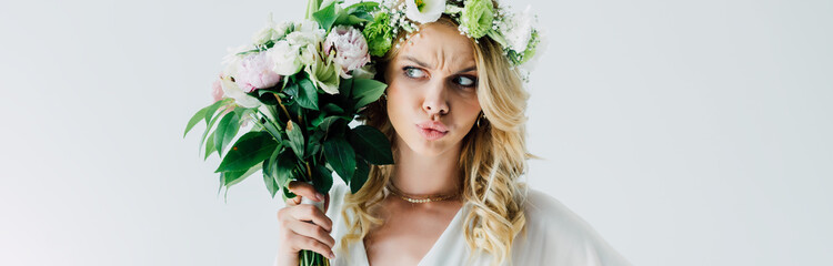 panoramic shot of attractive and blonde bride holding bouquet isolated on white