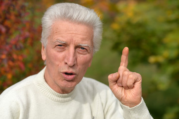 Portrait of a thoughtful senior man outdoors