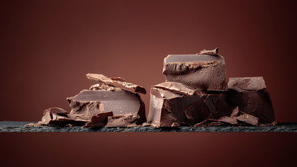 Black chocolate on a brown background.