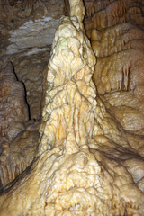 Secluded place. The dark depths of the earth. Caves. Stalactites and stalagmites inside the cave. A large stalagmite.