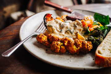 Warm hearty breakfast, lunch with organic farm curry veggies. Wood table. Slow food living concept, close up, food photography