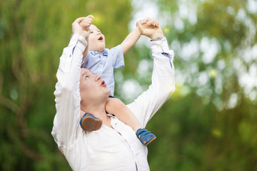 Portrait of a father with his son on his hands