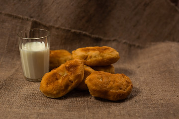 homemade pie and a glass of cow's milk on a bag