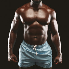 Fototapeta na wymiar Strong athletic african guy demonstrating naked muscular body