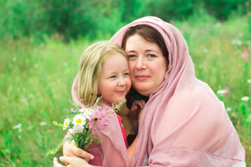 mother and daughter in a flower meadow