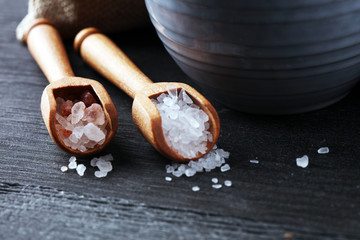 Sea salt and himalayan on spoon. Crystals of salt on dark background