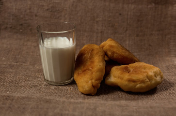 homemade pie and a glass of cow's milk on a bag