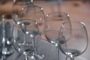 Wine glasses stand in a row