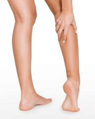 Woman with injured calf, massaging painful leg muscle