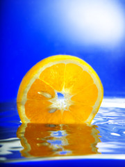 glass of orange juice on blue background