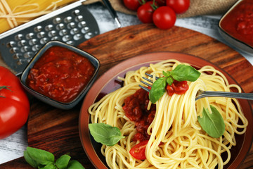 Plate of delicious spaghetti Bolognaise or Bolognese with savory minced beef and tomato sauce garnished with parmesan