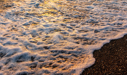 Waves on the seashore at sunset