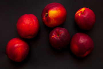 Ripe nectarine on a black background