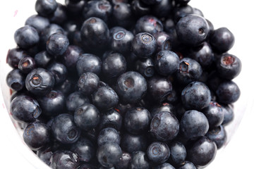 Blueberries in a glass on a white background