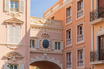 Fragment of an old building with a coat of arms and a crown in Monaco