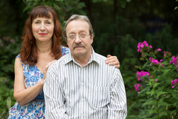 Elderly couple in the summer garden. Husband and wife