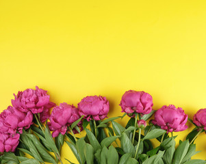 bouquet of red peonies with green leaves