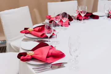 a place at the table served with a red napkin