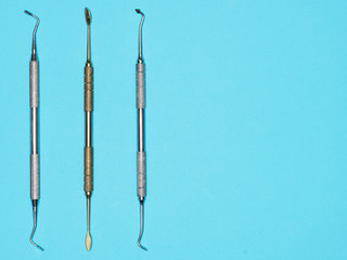 Dental instrument on blue background with copy space. Dental care concept