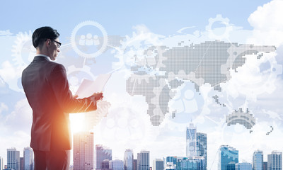 Concept of business success and control with confident boss against cityscape background