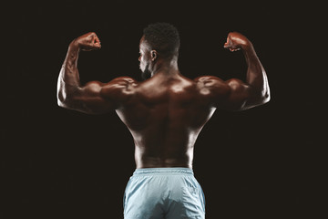 Fototapeta na wymiar Muscular black fitness model posing after exercises