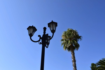 old street lamp on background of blue sky