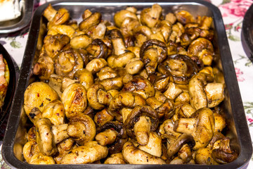 Fried champignons on the baking sheet. Close-up of fried mushrooms.